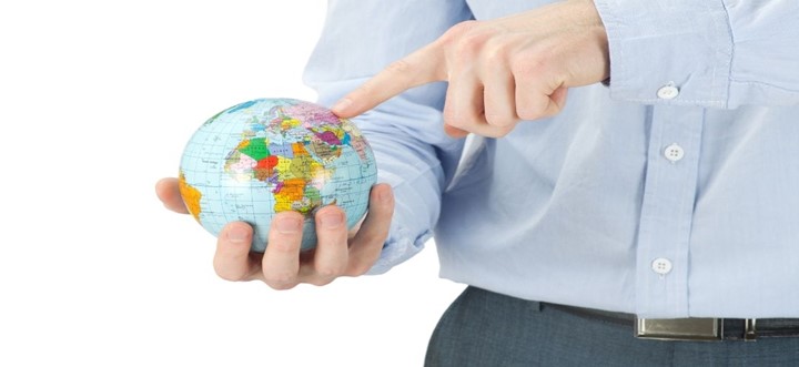 Diagram of man pointing at globe to answer the question: What is the best country for surrogacy