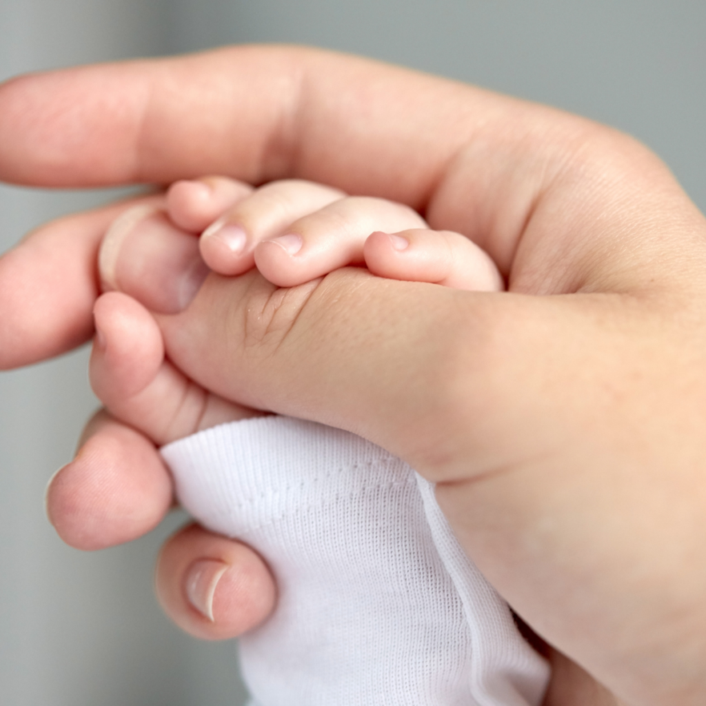 Holding a newborn's hand