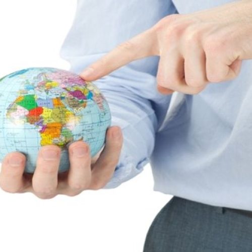 Diagram of man pointing at globe to answer the question: What is the best country for surrogacy